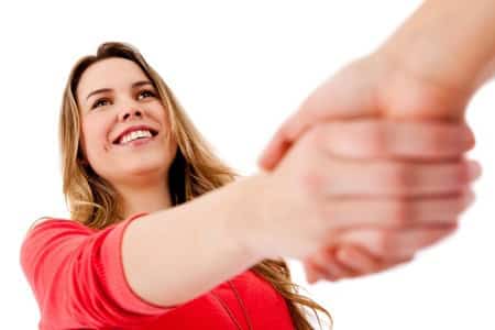 A woman shaking another persons hand